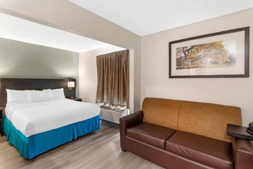 a hotel room with a bed and a couch at MainStay Suites Little Rock West Near Medical Centers in Little Rock