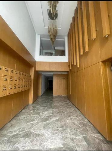 an empty hallway with a large room with a chandelier at Appartement à Khezama Est Sousse in Hammam Sousse