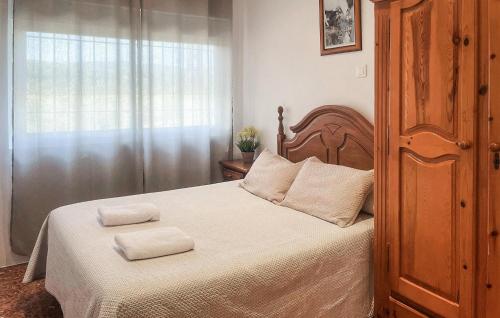 a bedroom with a bed with two towels on it at 6 Bedroom Amazing Home In Lucena in Lucena