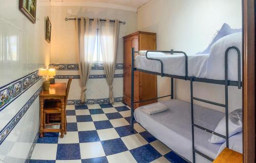 a room with two bunk beds and a checkered floor at 6 Bedroom Amazing Home In Lucena in Lucena