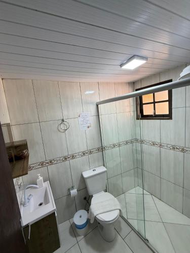 a bathroom with a toilet and a sink at Chalé Topázio in Monte Verde