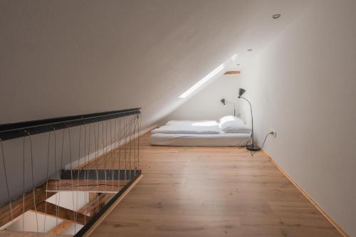a bedroom with a bed in the middle of a room at ATIK ROOMS in Ljubljana