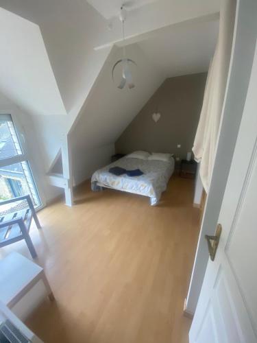 a small bedroom with a bed in a attic at OSTREA, gite 10pers avec piscine, billard et baby-foot in Sainte-Hélène