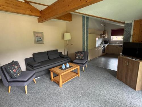 a living room with a couch and two chairs and a table at Landhaus Cornelia in Berwang