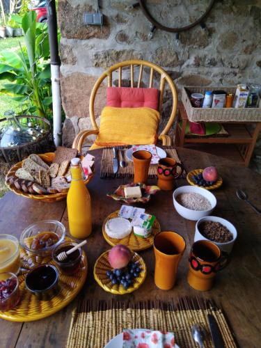 a table with plates and bowls of food on it at La chambre du lac in Meaux-la-Montagne
