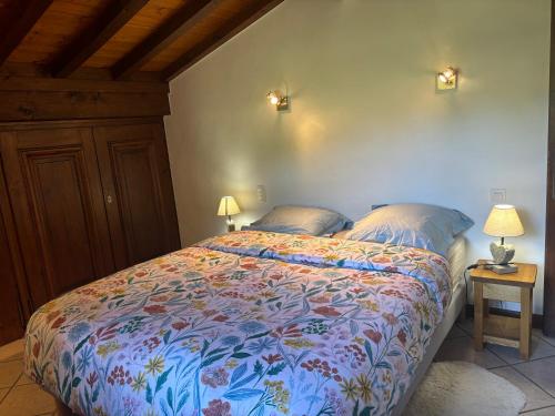 a bedroom with a bed with a colorful comforter at Le Mont in Demi-Quartier