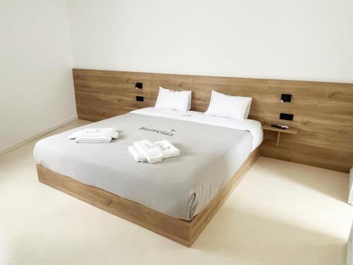 a bedroom with a bed with two towels on it at Guest House Barrelas in Vila Nova de Paiva
