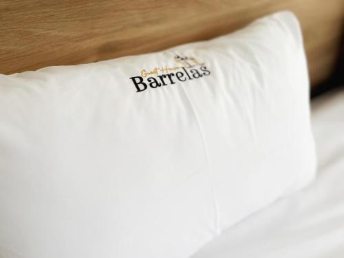 a white pillow with the words barcelona on it at Guest House Barrelas in Vila Nova de Paiva