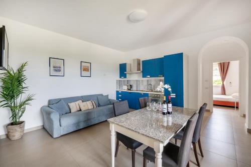 a living room with a table and a couch at Agriturismo Le Masciare in Paternopoli