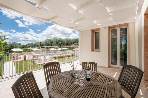 a dining room with a table and chairs and a balcony at Agriturismo Le Masciare in Paternopoli