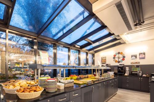 a large kitchen with lots of food on display at Hostel Art & Style in Singen