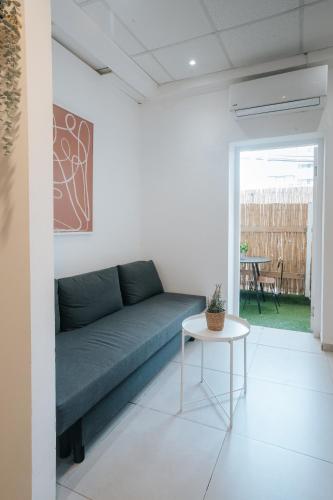 a living room with a couch and a table at מלון סנטרל ביץ תל אביב in Tel Aviv