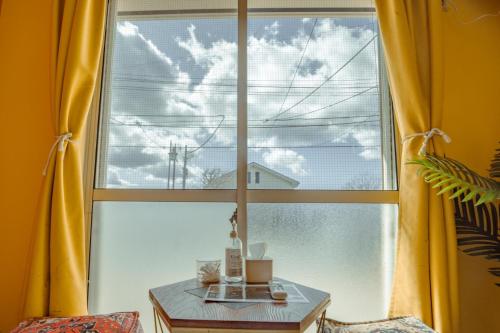 a table in front of a large window with yellow curtains at コ一ボ箱根 箱根中心 in Hakone