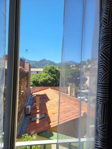 a view from a window of a roof at La roussette in Collioure