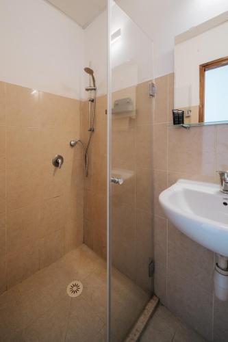 a bathroom with a shower and a sink at מלון סנטרל ביץ תל אביב in Tel Aviv