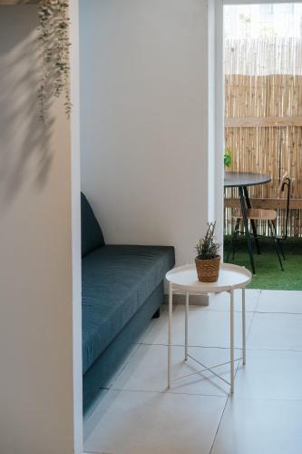 a living room with a couch and a table at מלון סנטרל ביץ תל אביב in Tel Aviv
