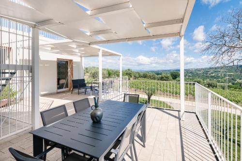 a patio with a black table and chairs at Agriturismo Le Masciare in Paternopoli