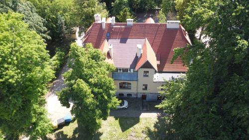 an overhead view of a large house with a red roof at Willa Dąbrówka in Szczawno-Zdrój