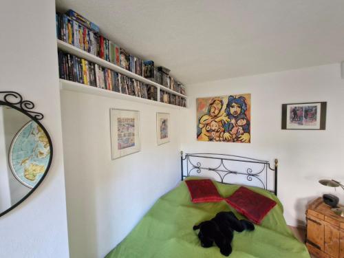 a bedroom with a bed with a green comforter at Ferienwohnung Spirou in Waldesch