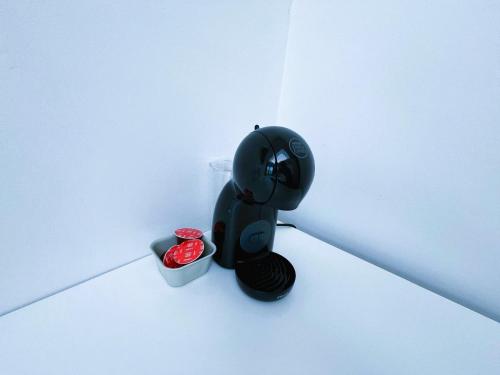 a black object sitting in the corner of a room at Bella Apartments Brno in Brno