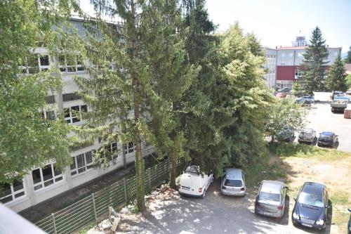 a group of cars parked in a parking lot next to a building at Apartman Sweet in Prijedor