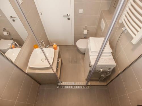 a bathroom with a toilet and a sink and a mirror at Villa Krasici in Tivat