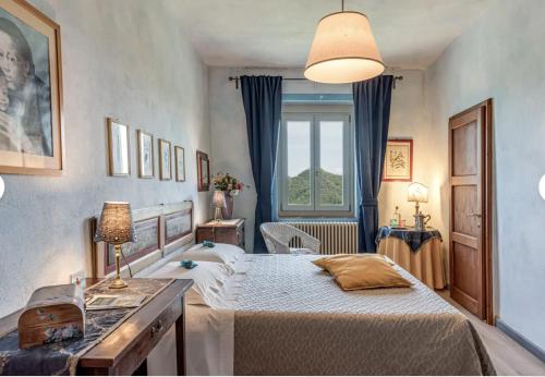 a bedroom with two beds and a window at Historic Villa In The Florence Hills in Borgo San Lorenzo