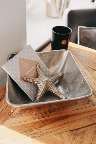 a starfish sitting on a tray on a table at Boutique Hotel Villa Monika in Westerland (Sylt)