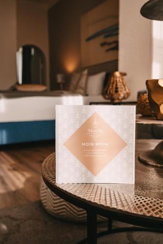 a sign on a table in a room at Boutique Hotel Villa Monika in Westerland (Sylt)