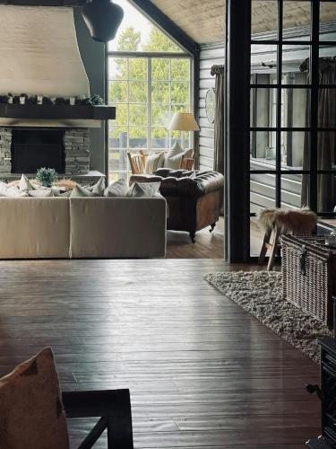 a living room with a couch and a fireplace at Spacious Family Cabin In Western Golsfjellet in Gol