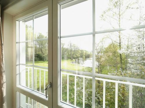 an open window with a view of a river at Charming House At Häckeberga Nature Reserve in Svedala