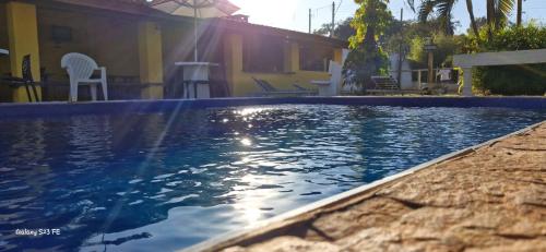 a swimming pool in front of a house at Pousada Boa Vista in Brotas