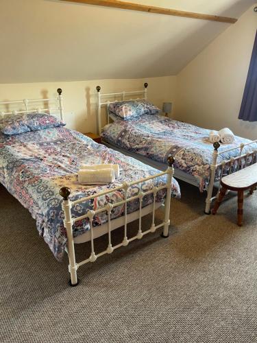 two beds sitting next to each other in a room at St Judes, Mundesley in Mundesley