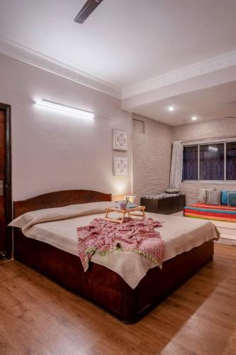 a bedroom with a large bed in a room at BOHO Bari in Kolkata