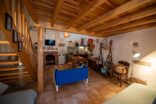 a living room with a staircase and a fireplace at Casa do Guardado in Monsanto