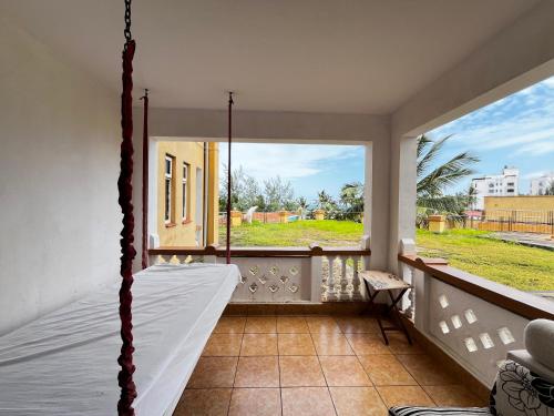 蒙巴萨Magnificent Beachfront Holiday Homes的带吊床和大窗户的门廊