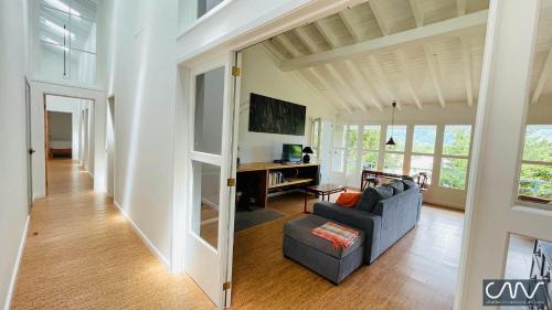 a living room with a couch and a tv at Challet Miradouro do Vale in Furnas