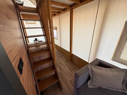 a staircase leading up to a room with a couch at Luna Glamping de Luxe in Drage