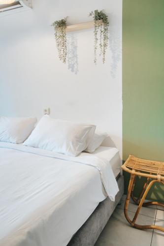 a bedroom with a white bed and a table at מלון סנטרל ביץ תל אביב in Tel Aviv