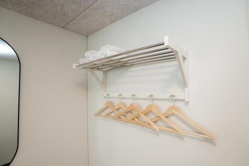 a shelf in a room with wooden hangers at Omena Hotel Joensuu in Joensuu