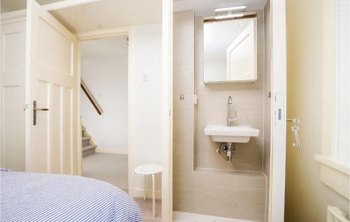 a small bathroom with a sink and a mirror at 'T Sterntje in Bergen aan Zee
