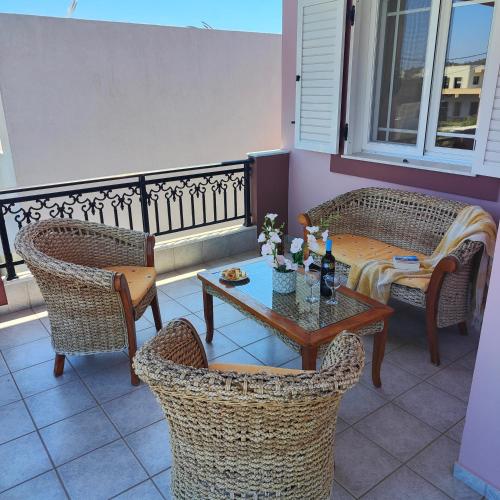 a balcony with a table and chairs on a balcony at Aithrea's HOMES in Pastida Rhodes in Pastida
