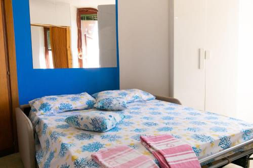 a bed with pillows on it in a room at Teulada cozy flat with pool and beach access in Teulada