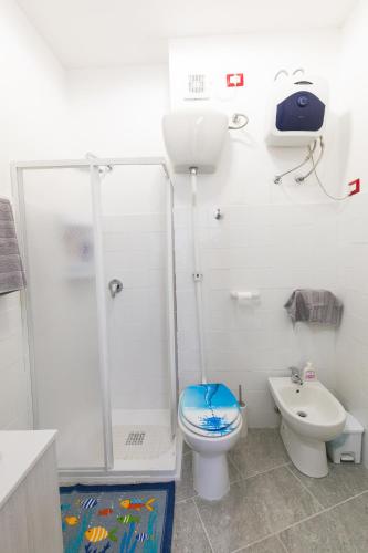 a bathroom with a shower and a toilet and a sink at Teulada cozy flat with pool and beach access in Teulada