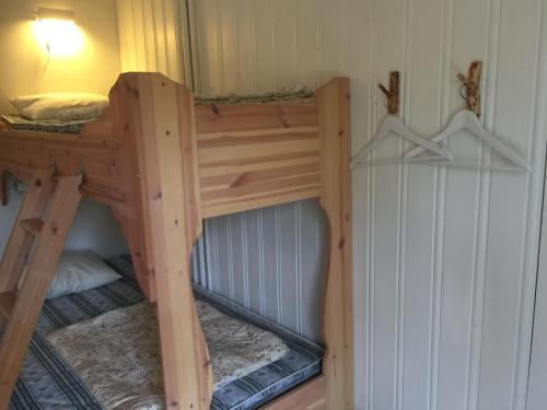 a wooden bunk bed in a room at Norrsjön in Sörsjön