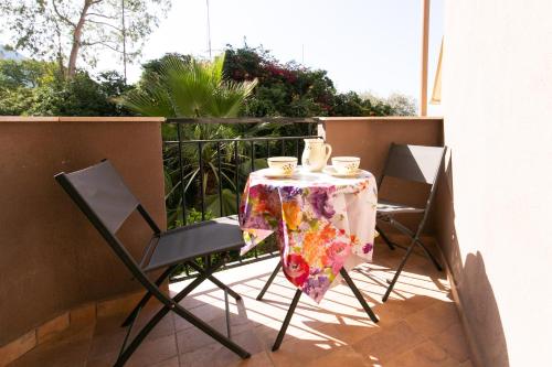 a table and two chairs on a balcony at Teulada cozy flat with pool and beach access in Teulada