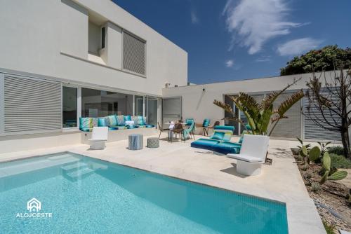 a villa with a swimming pool and a house at The Wild Ocean in Santa Cruz