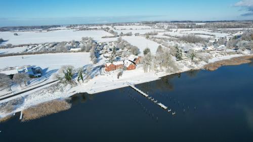 an aerial view of a house on an island in the water at Appartementhaus Schleiblick in Kappeln