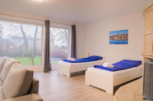 a living room with two beds and a couch at Appartementhaus Brunsholm in Esgrus