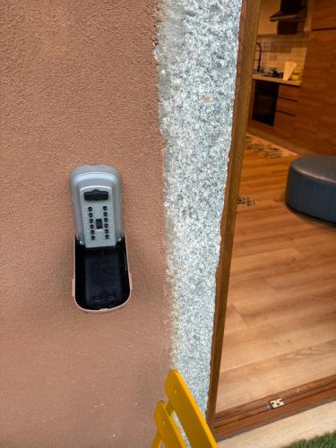 a wall with a cell phone in a wall at Luna Home in Arona